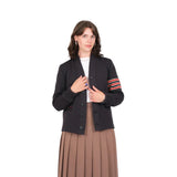 Woman wearing a black cardigan with red and white stripes on a white background