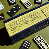 Domino set with a box on a green surface