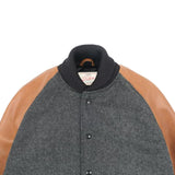 Gray varsity jacket with brown sleeves on a white background