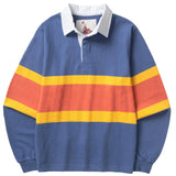 Front of a light blue rugby shirt with a white collar and hidden placket. There is a wide horizontal orange stripe in the center of the shirt with a thinner yellow stripe on the top and bottom of the orange one.