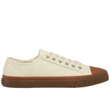 Side profile of off-white low-top canvas sneaker with gum sidewalls and toe cap, silver grommets, and white laces