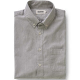 Folded gray and white striped shirt on a white background