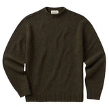 Front of a dark olive-colored sweater with a mock neck and little colored flecks in the knitting. The cuffs and bottom hem are ribbed