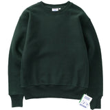 Dark green sweatshirt with a brand tag on a light gray background