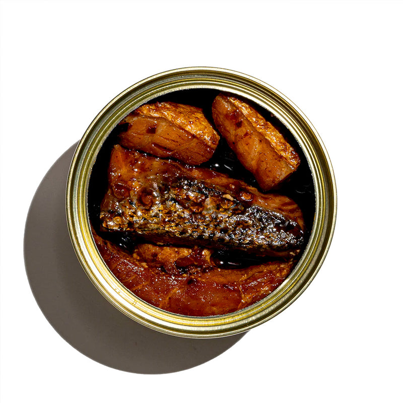 'an open tin of smoked salmon with sichuan chili crisp fly by jing sauce'