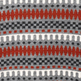Close up of geometric pattern in red, grey, white, and black