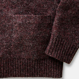 Close-up of a dark brown knitted sweater on a white background