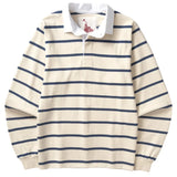 Front of an off-white rugby polo with long sleeves, a white collar, and thin horizontal navy blue stripes