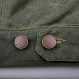 "waist adjustment buttons on the waxed canvas olive western style jacket with southwestern blanket lined body and satin lined sleeves"