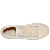 Top-down view of a white canvas high-top sneaker with white laces, silver grommets, and beige rubber side walls and toe cap