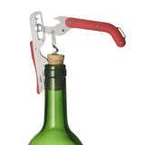 Wine bottle with a corkscrew being used to open it on a white background
