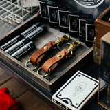 Two leather keychains next to lip balm and a deck of playing cards