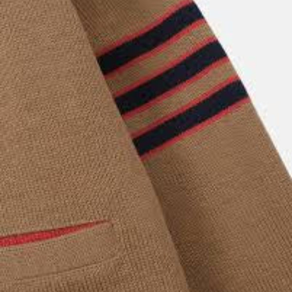 Close-up of a brown sweater with red and black striped details on a white background