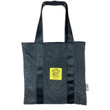 Black tote bag with black straps on a white background. 