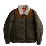 Puffy dark green winter coat with a white sherpa collar and a brown leather shoulder patch on a flat white background