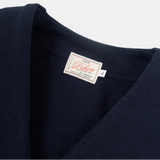 Navy sweater with a visible label on a white background
