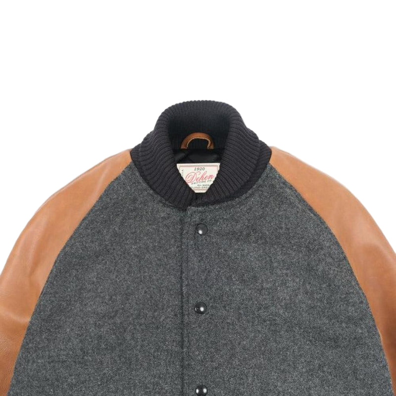 Gray varsity jacket with brown sleeves on a white background