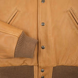 Closeup of buttons and ribbing around sleeve opening and bottom hem