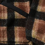 Close up of angled hand pocket and sleeve opening of brown and black plaid fleece jacket
