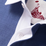 Close up of placket on a light blue rugby shirt showing hidden white rubber buttons.