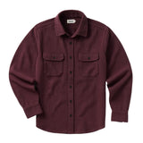 Front of dark burgundy long sleeved button up shirt with black buttons going down the center and two chest pockets with black button-secured flaps. 