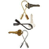 Trio of loop key holders with one key on each arranged vertically. The bronze keyring is on top, black in the middle, and steel on the bottom. 