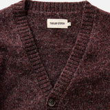 Close-up of a maroon sweater with 'Taylor Stitch' label on a white background