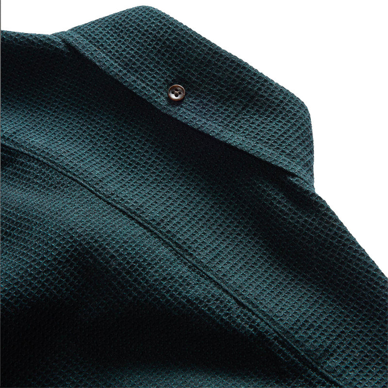 "Long sleeved Forest green collared shirt with brown buttons"