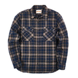 Front of a long sleeved button up flannel plaid shirt in shades of dark blue, off-white, and yellow. There are two button-secured chest pockets and a row of dark buttons going down the center of the shirt. 