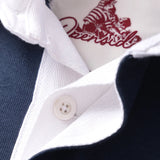 Closeup of hidden placket on a navy rugby polo with a white collar and white rubber buttons