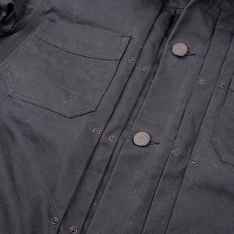 "chest pocket and front buttons on the black freenote riders jacket"