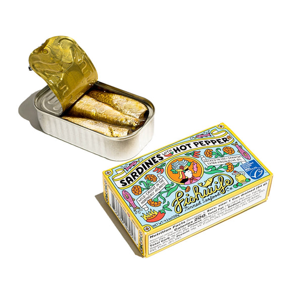 "A colorful box with cartoons on it containing canned sardines with hot peppers and an open can of sardines"
