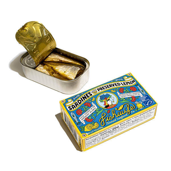 "A colorful box with cartoons on it containing canned sardines with preserved lemon and an open can of sardines"