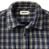 Close up of collar of navy blue, white, and black plaid shirt