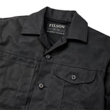 " close up on collar and chest pockets one of which has a button flap and the other has three tool slots on the lined black canvas jacket with collar and lots of pockets"