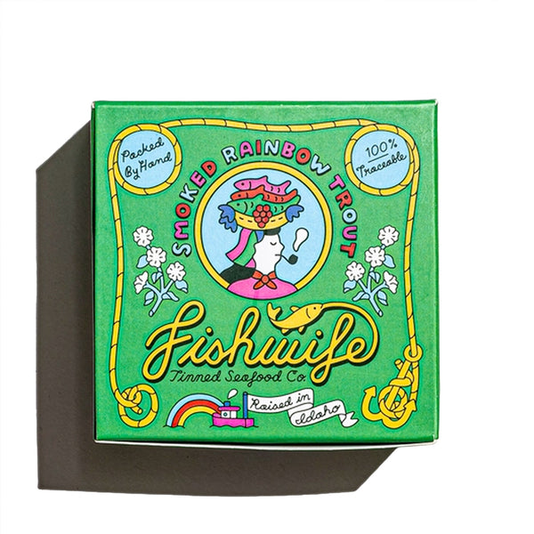 "A colorful box with cartoons on it containing canned smoked rainbow trout"