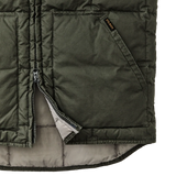 Closeup of bottom of vest partially unzipped and front pocket