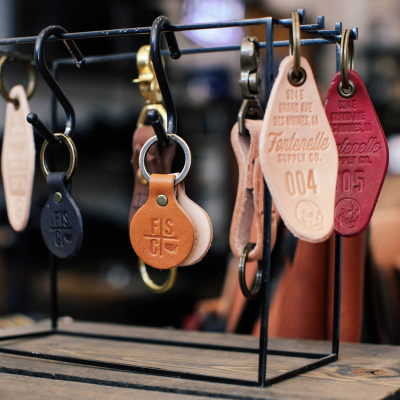 Custom leather keychains hanging on a rack