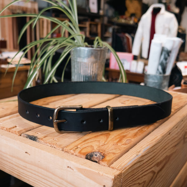 A Black Belt With Antique Brass Hardware.