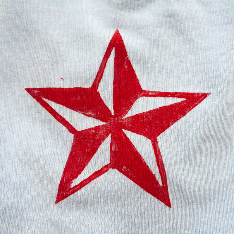 light blue tee with black anchor and red star boy